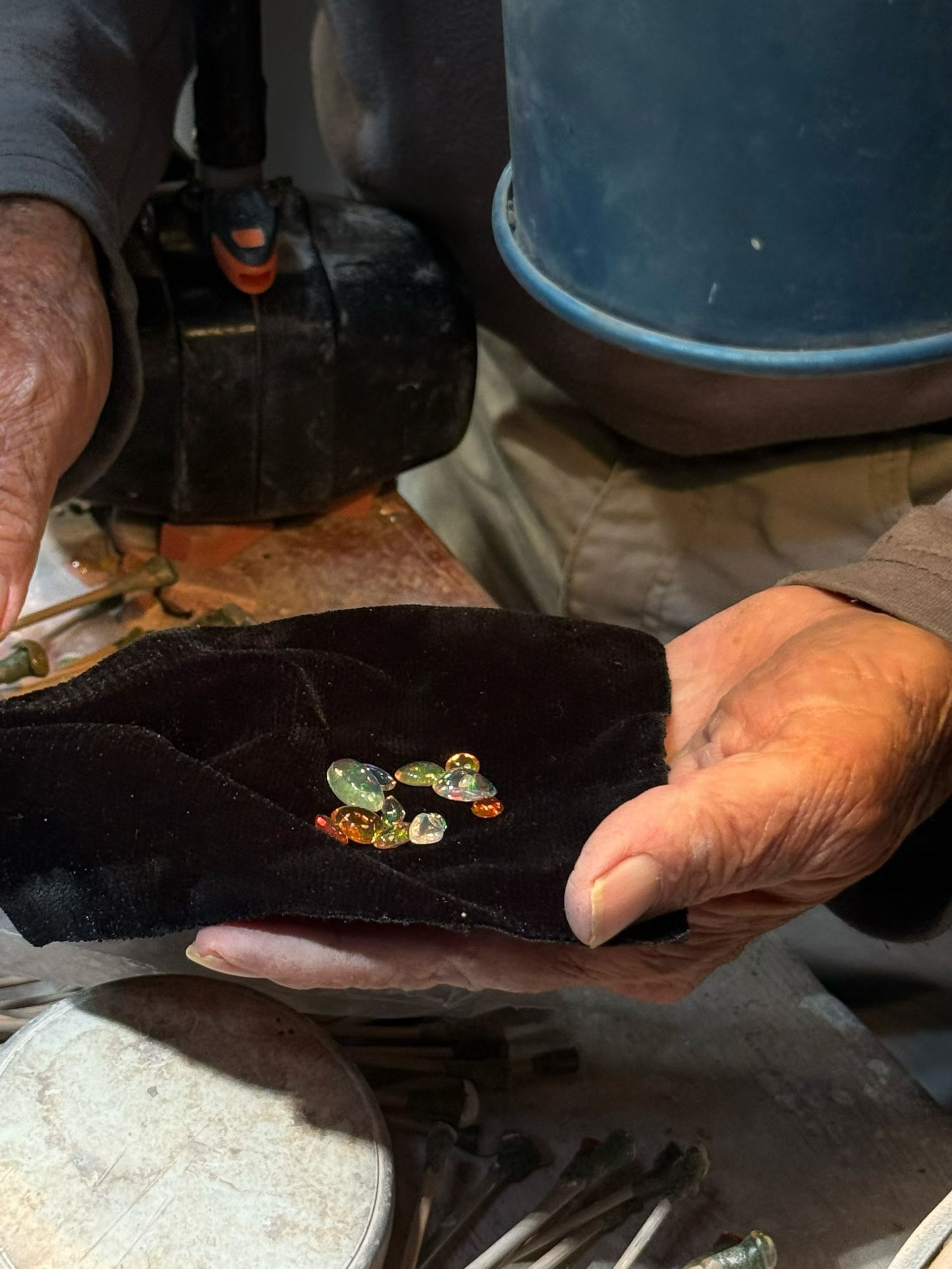 A jeweler selecting natural gemstones by hand